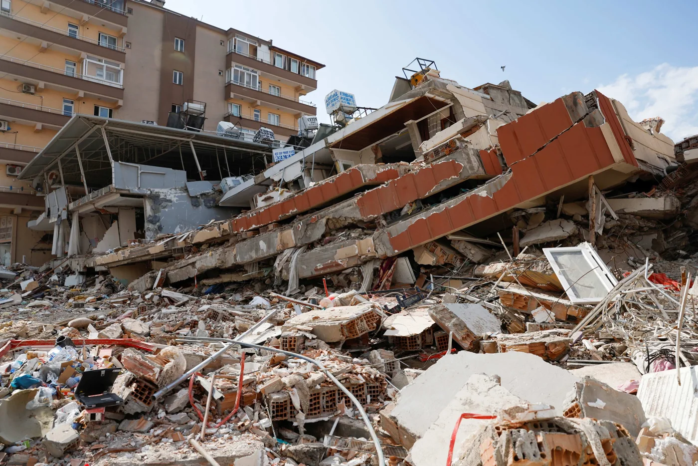 A collapsed building and rubble after an earthquake