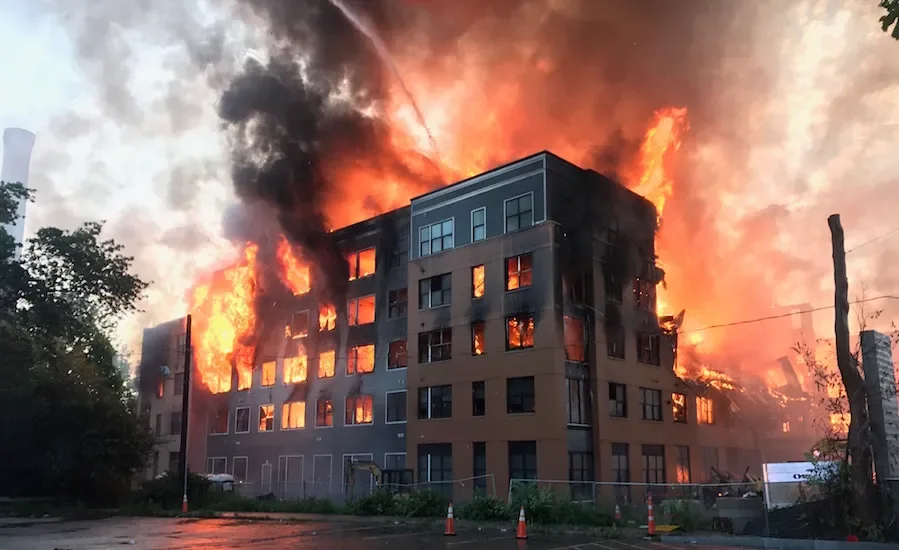 Flames and smoke engulfing a multi-story building