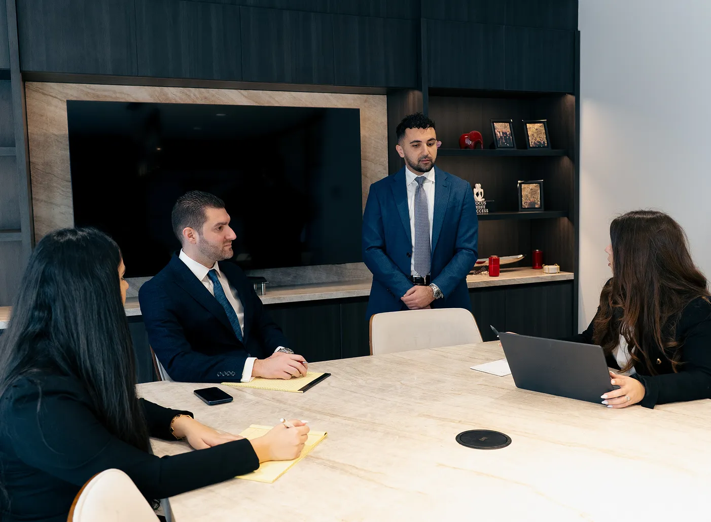 The Hamassian Law team discussing a case around their conference table